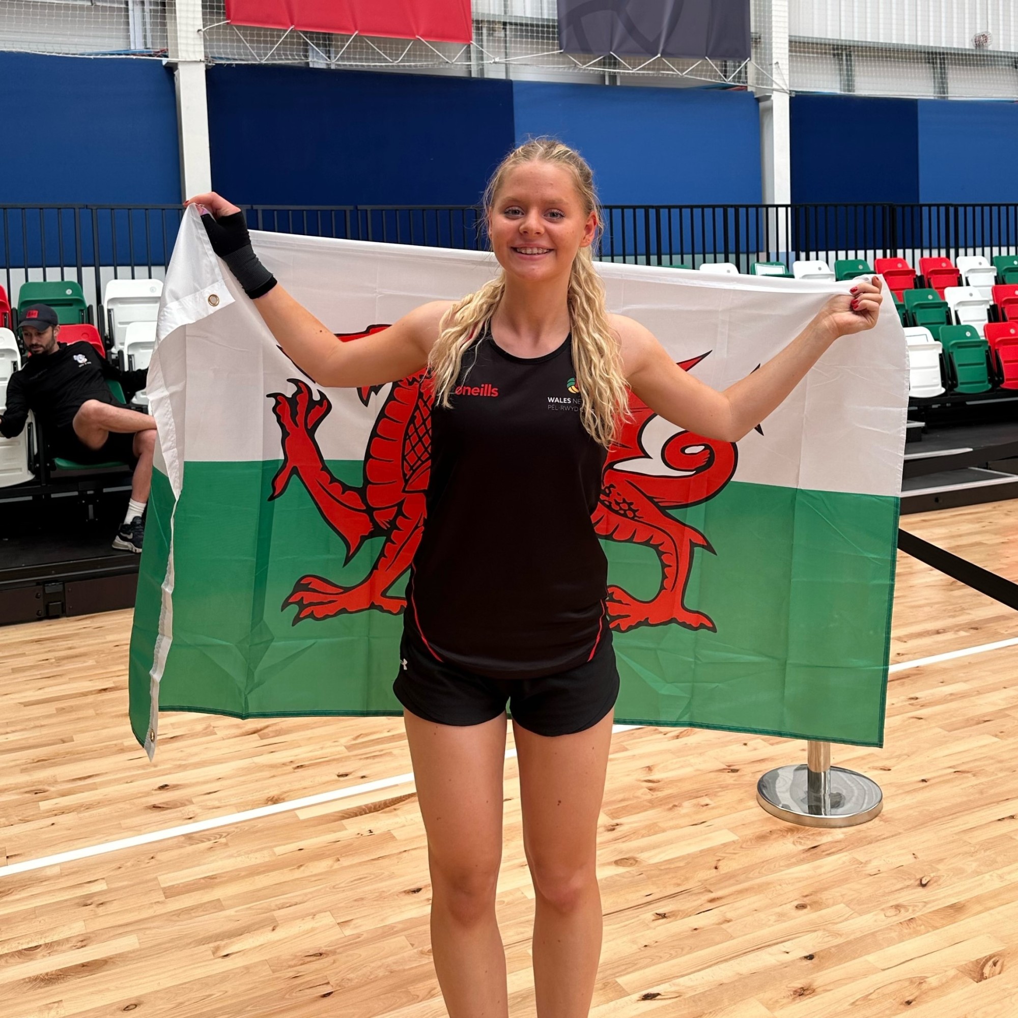 Hana holding a Welsh flag at House of Sport