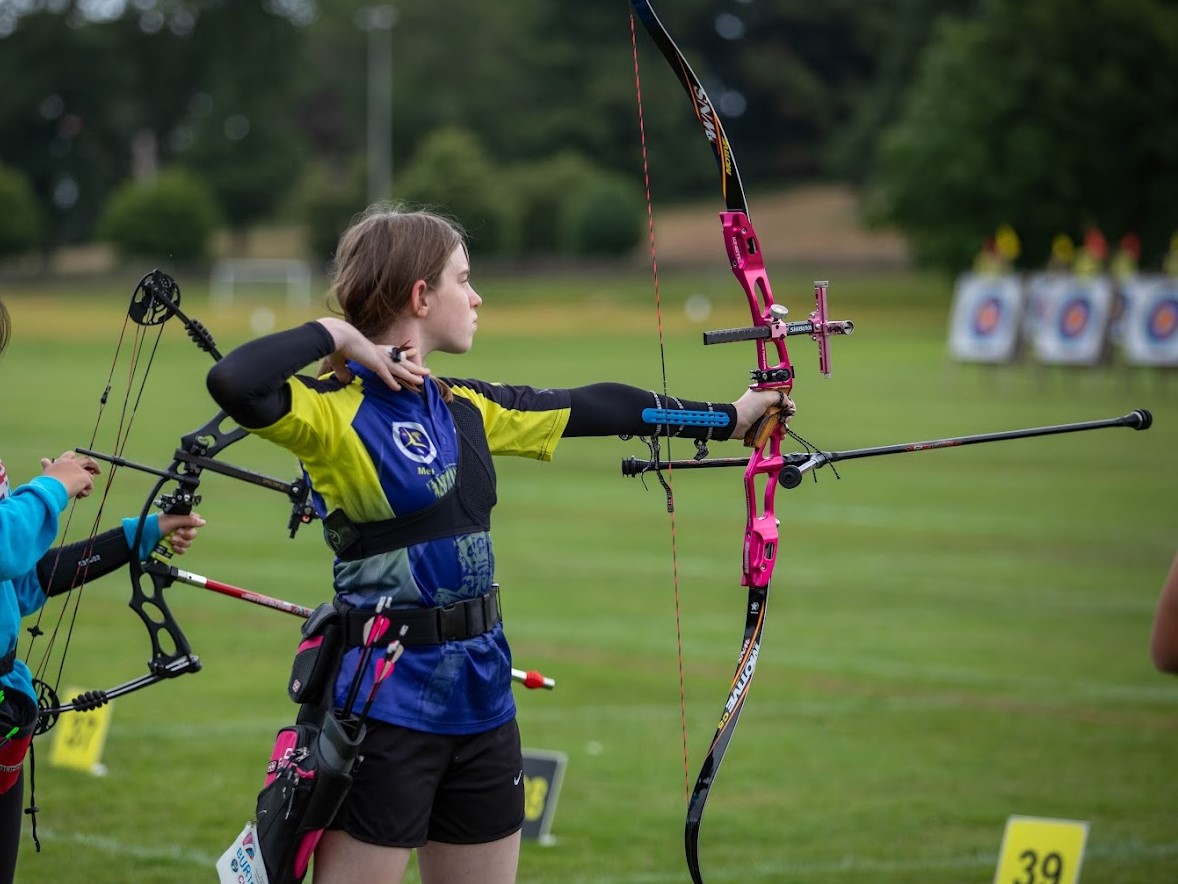 Meredith performing at the UK Junior Masters archery event