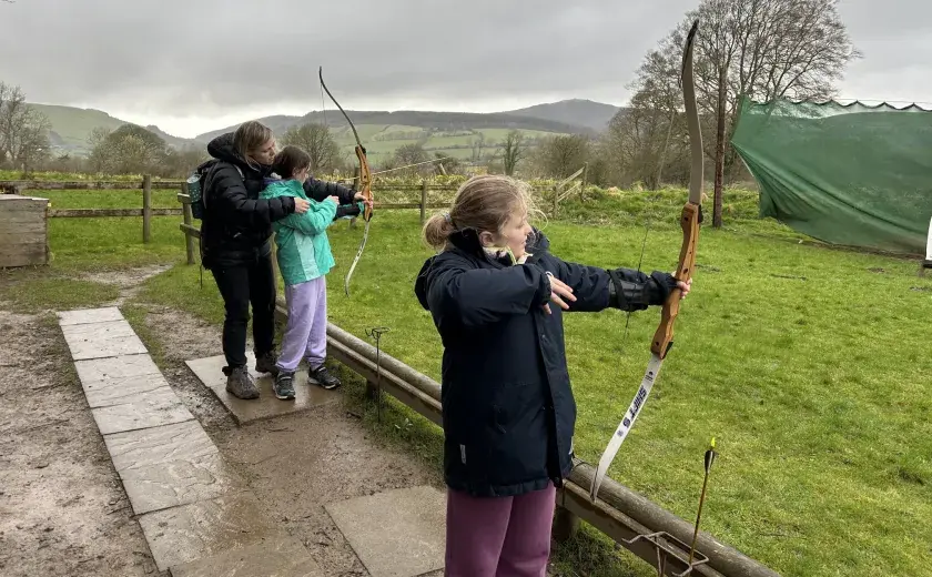 Year 4 girls trying out archery